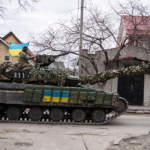 ukrainian-tank-carrying-soldiers-drives-down-a-road-in-irpin-24-february-2022_getty-images_866-486